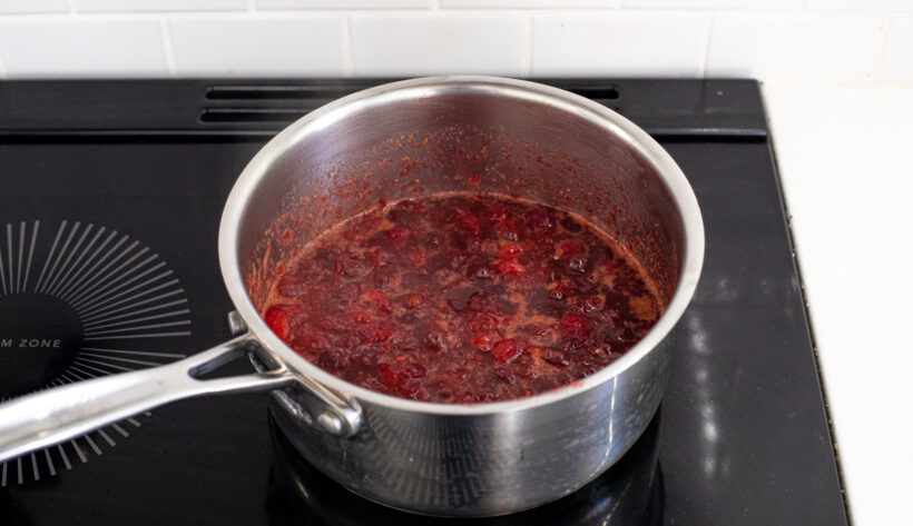 cooked orange cranberry sauce in small saucepan
