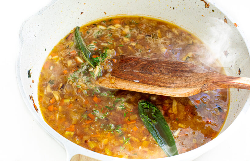 Broth added to sauteed veggies in skillet.