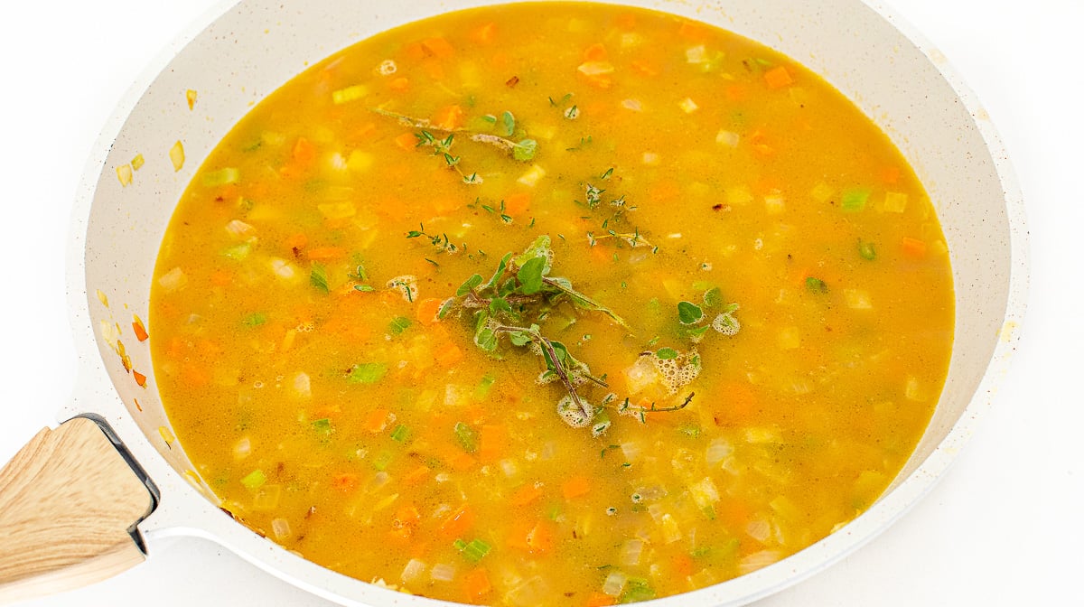 Simmering broth in a skillet.