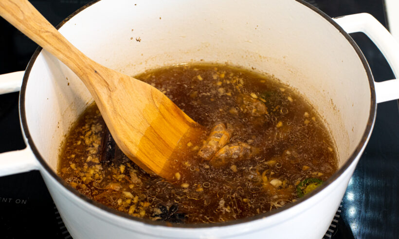 simmering seafood broth in cast iron pot