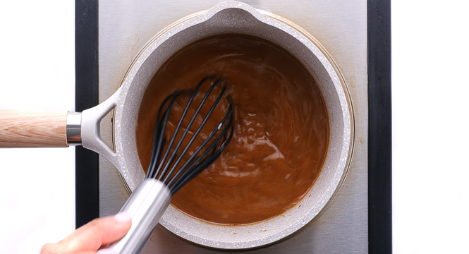 whisking teriyaki sauce in small saucepan