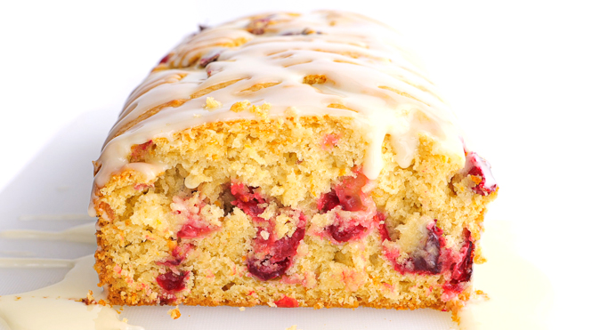 sliced cranberry orange bread on white cutting board