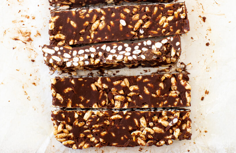 Healthy Crunch Bars sliced into bars on a parchment paper.