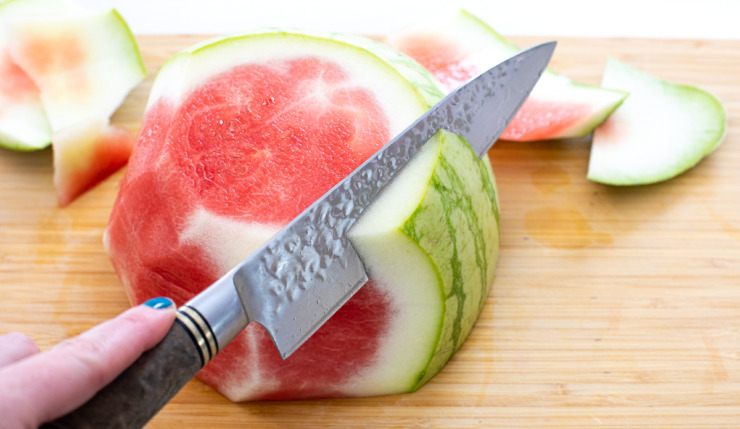 cutting rind off of watermelon