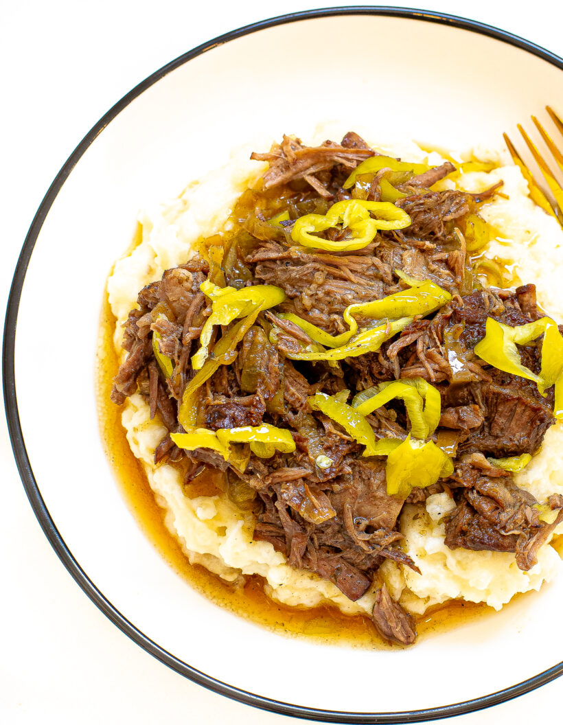 Shredded italian beef on a bed of mashed potatoes.