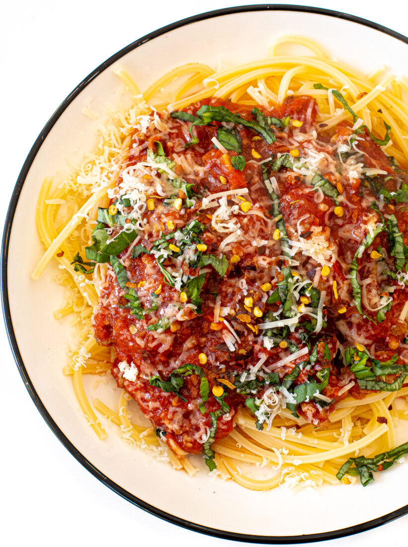 overhead shot of spaghetti topped with homemade slow cooker tomato sauce