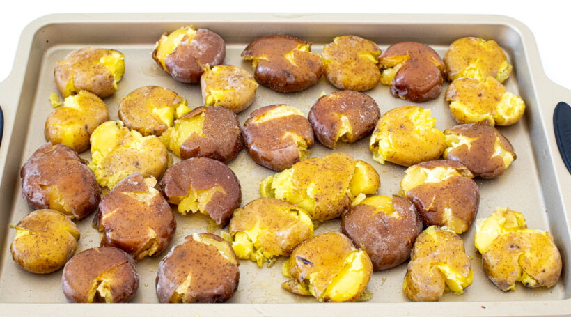 Smashed potatoes on a baking sheet.