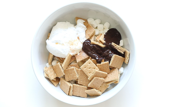marshmallow fluff, melted chocolate, marshmallows and graham crackers in a medium bowl