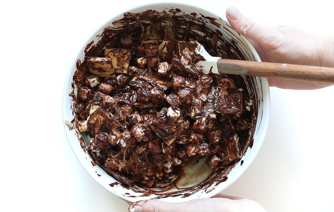 Tossing ingredients togther for Smores Bars Tossing ingredients togther for Smores Bars in large white bowl