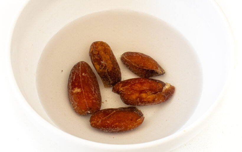 Dates soaking in water in a bowl.