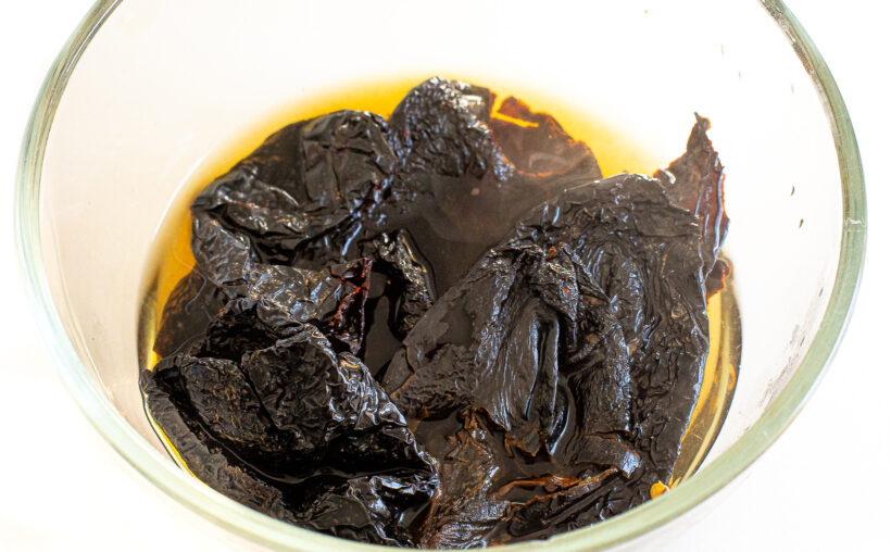 Ancho chilies soaking in boiling water.