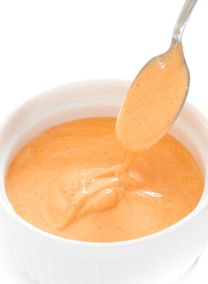 Spicy Mayo recipe in a small bowl with a spoon lifting some spicy mayo.