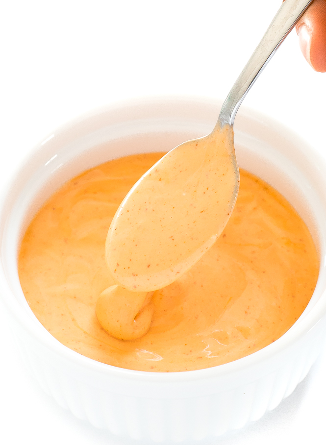 Spicy Mayo recipe in a small bowl with a spoon lifting some spicy mayo.