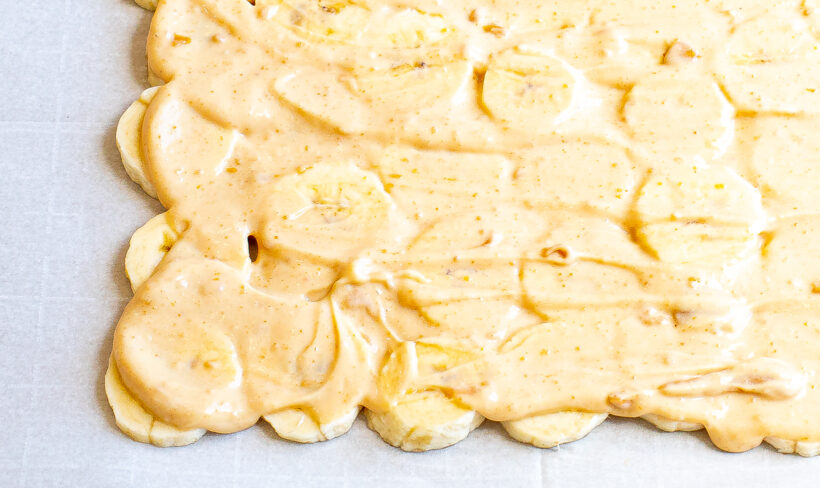 Peanut butter and yogurt spread onto the layer of banana slices. 