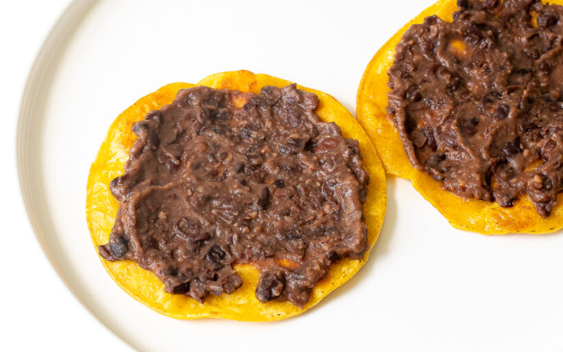 Tostadas with layer of refried beans on top. 