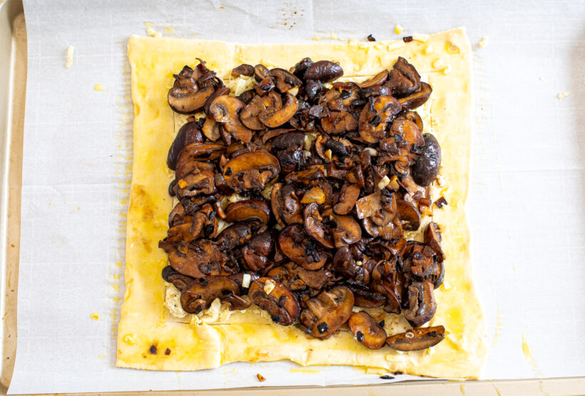 Mushroom tart on a sheet pan before being baked. 