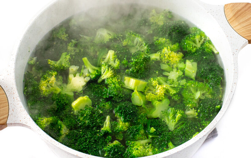 Broccoli boiling in a large pot.