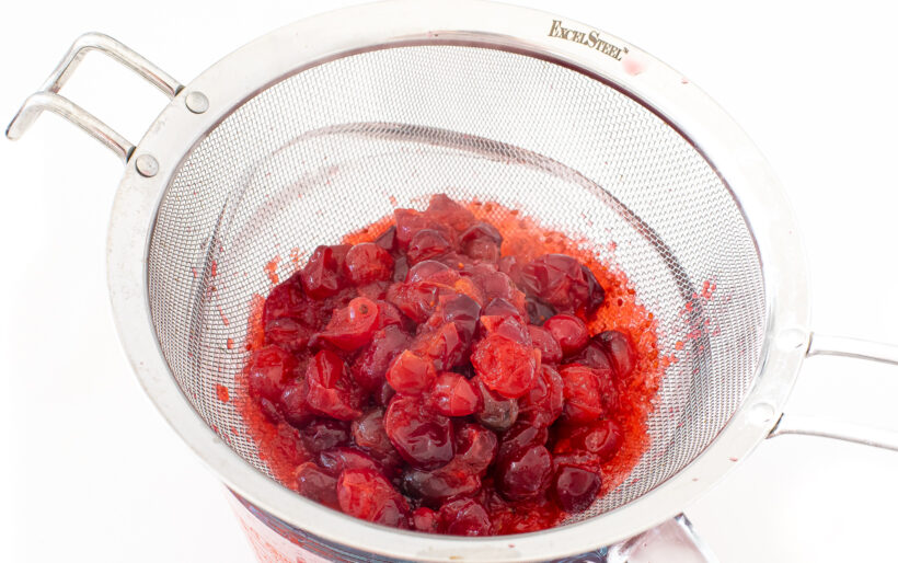 cooked cranberries in a colander