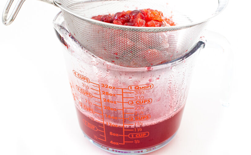 straining liquid from cranberries