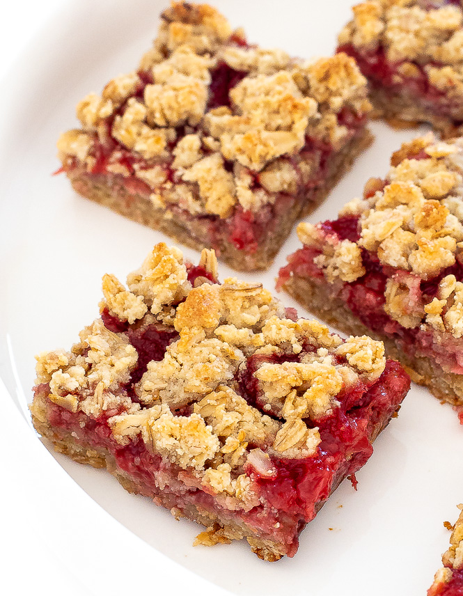 Strawberry oatmeal bars on a white plate.