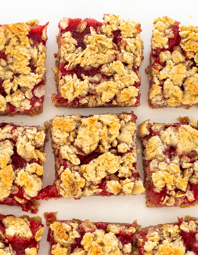 Strawberry bars lined up on a white plate.
