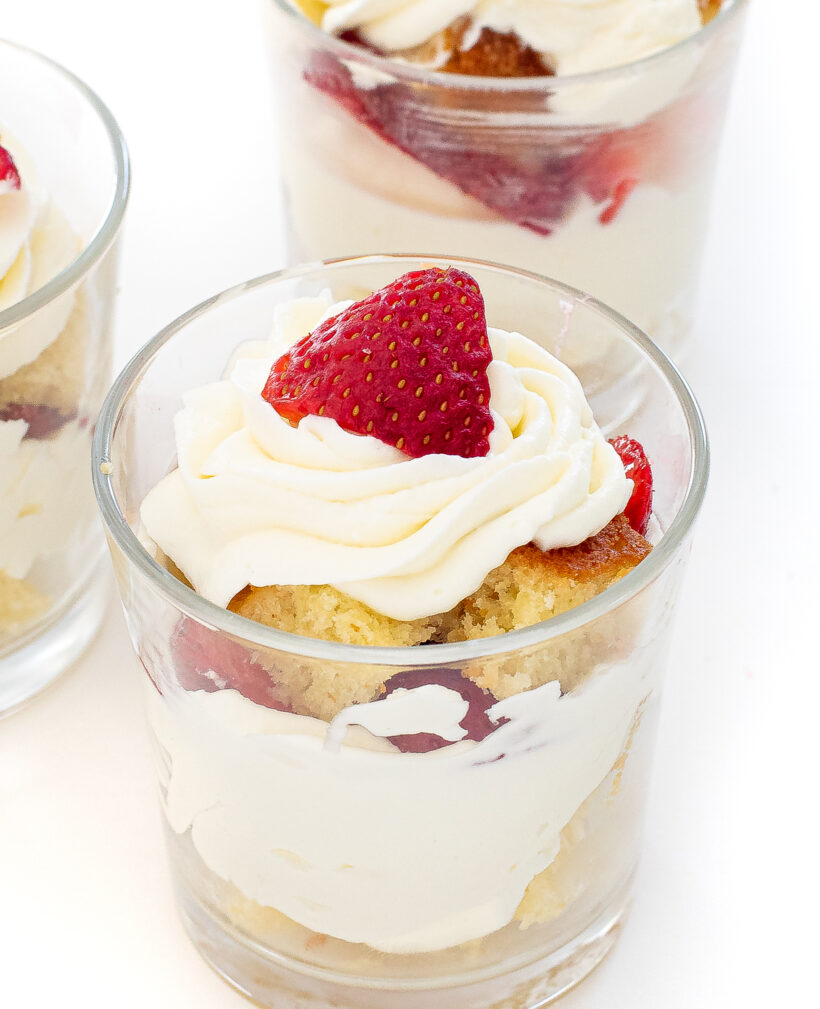 Mini strawberry shortcake assembled in a clear glass. 