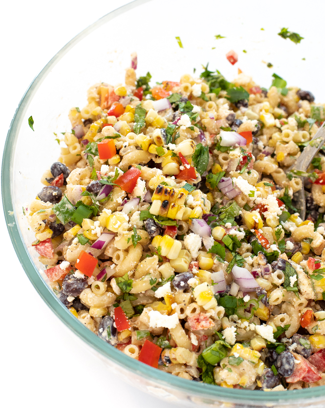Mexican Street Corn Pasta Salad in a clear mixing bowl.