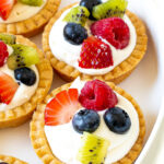 These Mini Fruit Tarts are the perfect individual-sized dessert for spring and summer! Each tart is made with a buttery crust and filled with mascarpone cream, then topped with fresh fruit. They’re as pretty as they are delicious!