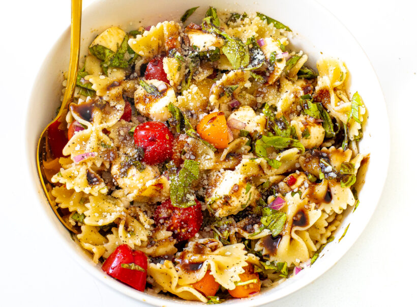 Pasta salad mixed up and topped with balsamic drizzle and parmesan cheese. 