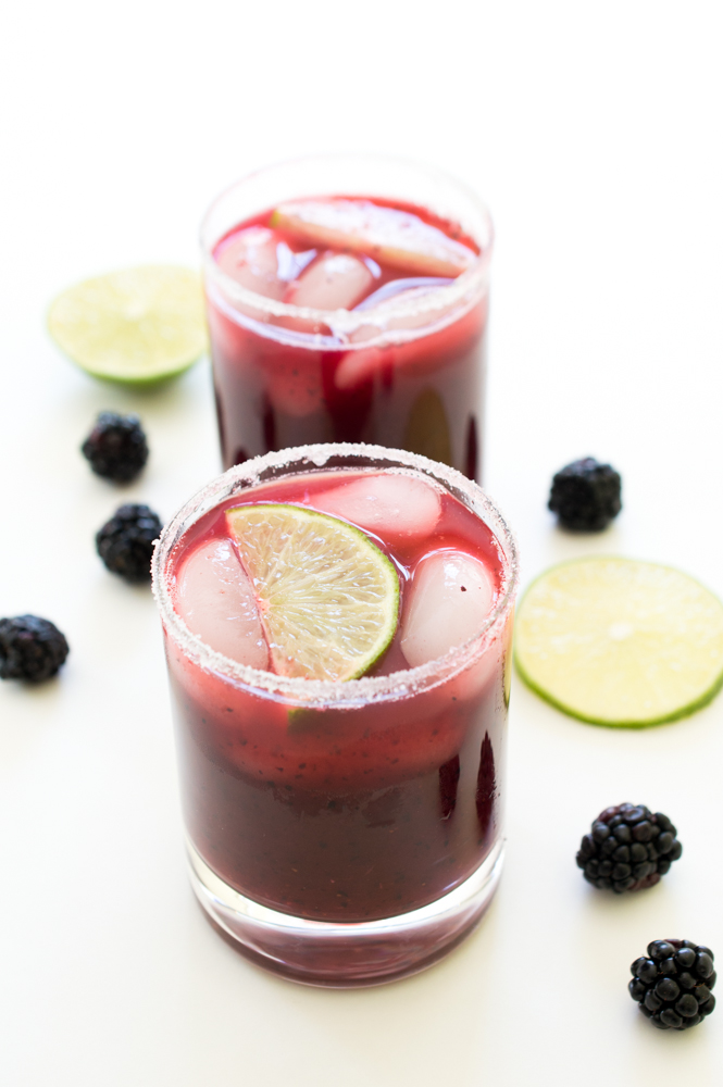 Mixed Berry Margaritas Two Mixed Berry Margaritas in glasses with blackberries and lime wedges as garnish | chefsavvy.com #recipe #drink #cocktail #margarita #beverage