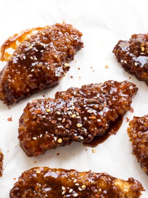These Sweet and Spicy Asian Chicken Tenders are baked until golden brown then tossed in a sticky Asian sauce. Serve with rice and veggies!