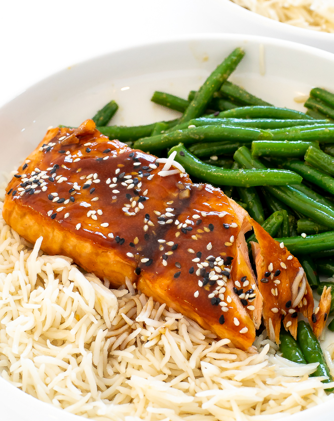 flaked salmon in white bowl topped with sesame seeds