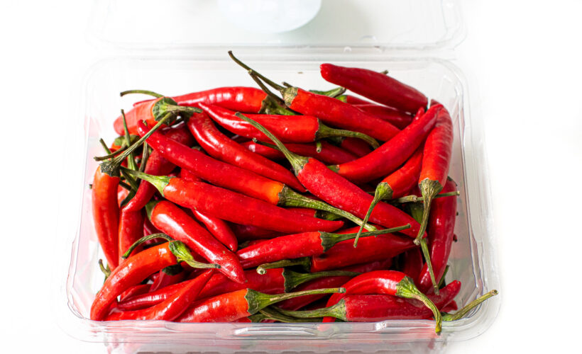Thai red chilies in a plastic container.