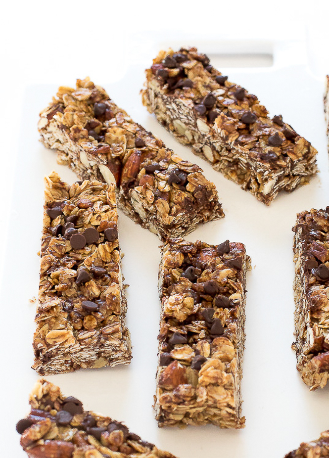 Granola Bars | chefsavvy.com Chocolate Chip Granola Bars on a white chopping board.