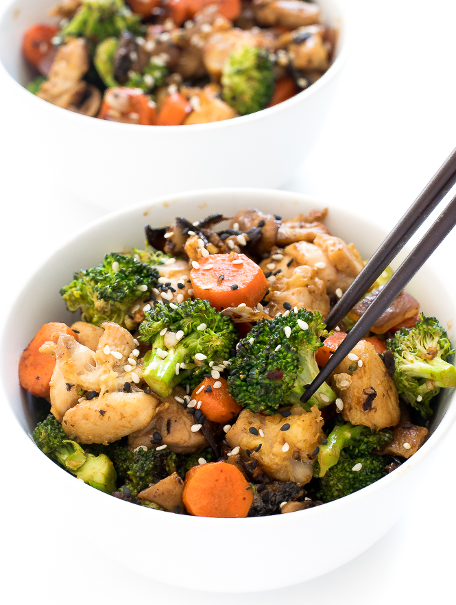 easy chicken stir fry in a white bowl with wooden chopsticks. 