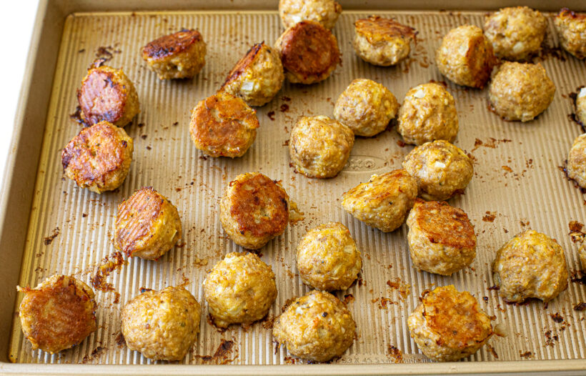 Cooked meatballs on a baking sheet.