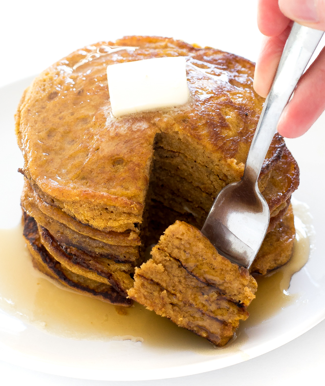 Light and fluffy pancakes | chefsavvy.com serving bite of pancakes on white plate