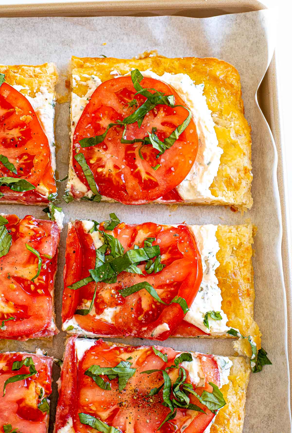 homemade puff pastry with ricotta cheese and sliced tomatoes on top