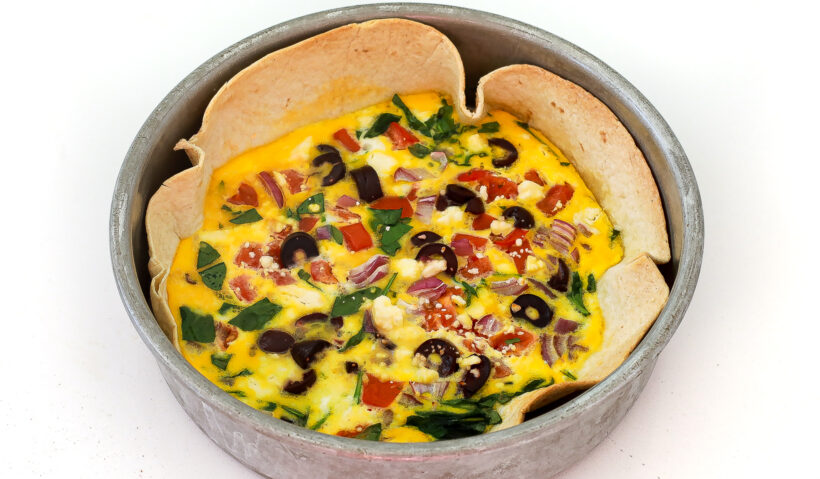 Tortilla baked eggs after being baked in a cake pan.