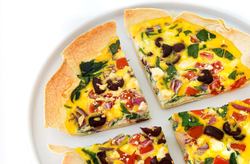 Serving four pieces of tortilla eggs on a plate.