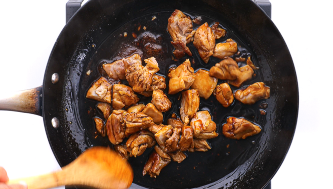 tossing chicken in teriyaki sauce