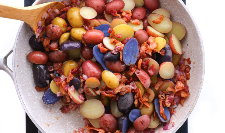 tossing potatoes in bacon and mustard sauce