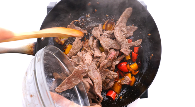 adding flank steak back to the skillet