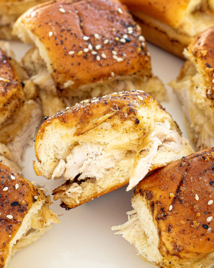 Side view of a turkey cheese slider with more sliders around it.