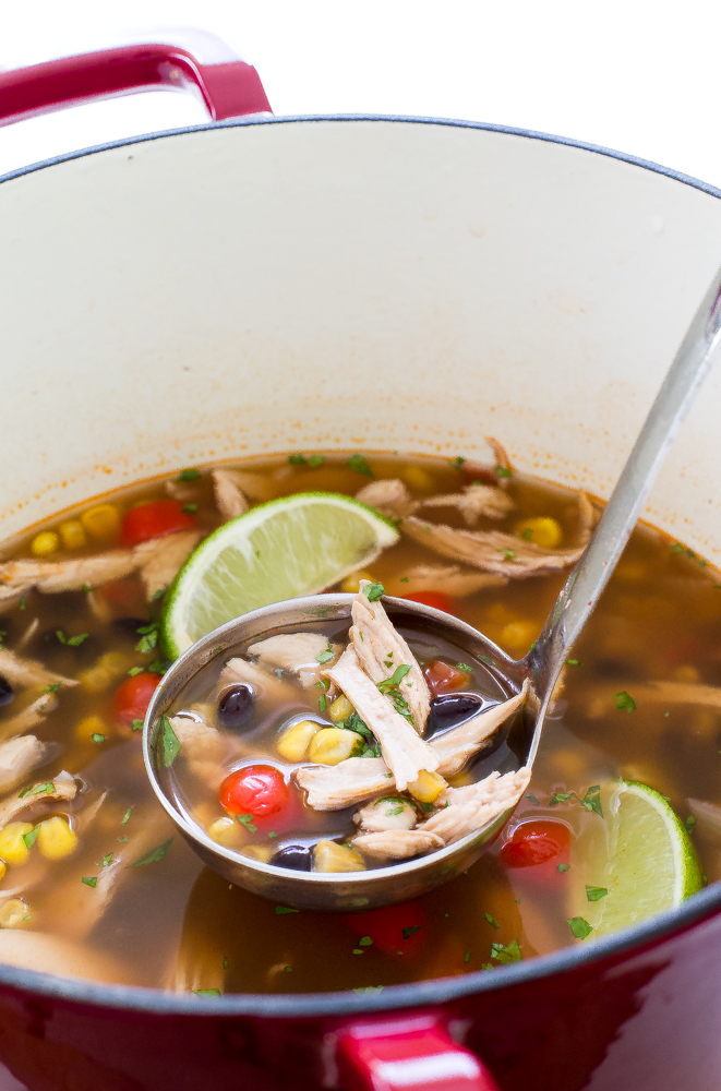 turkey tortilla soup in ladle over pot