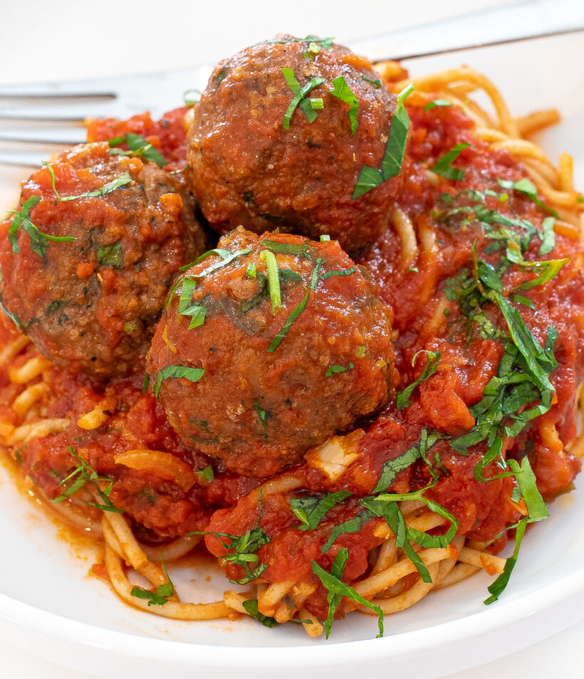 meatballs and spaghetti tossed in tomato sauce
