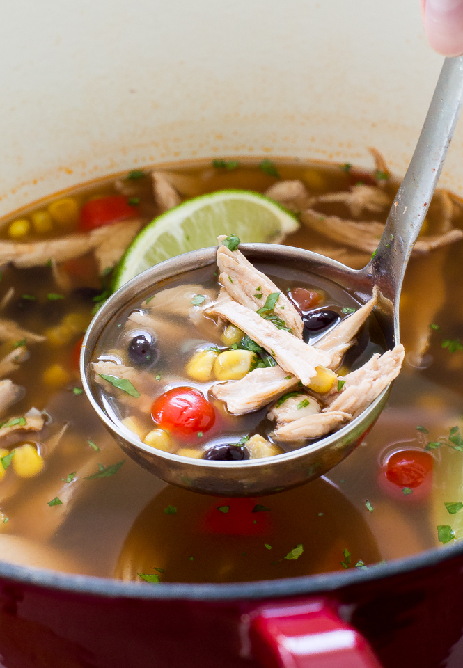turkey tortilla soup in ladle over pot