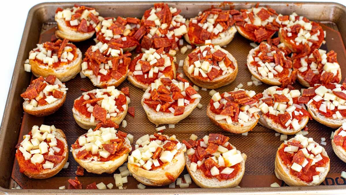 unbaked bagel bites on baking sheet