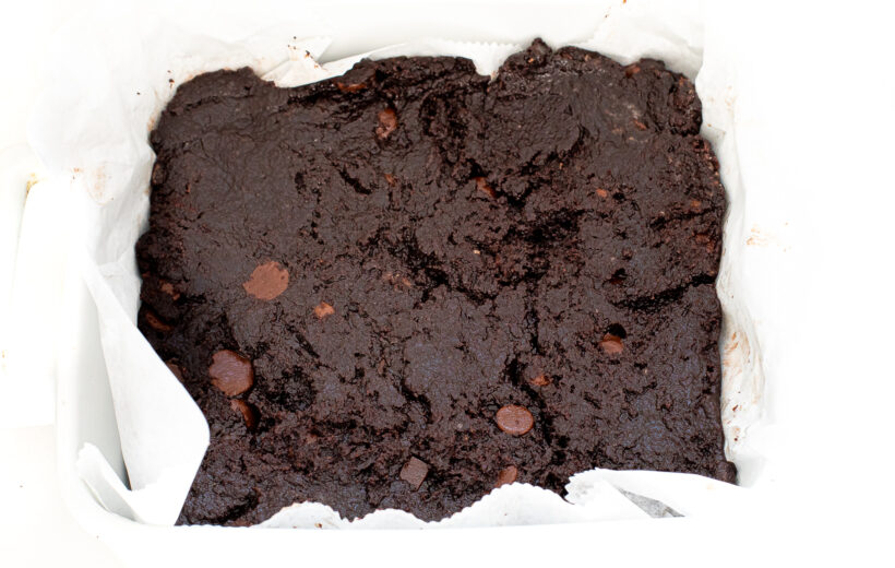 unbaked brownies in white casserole dish