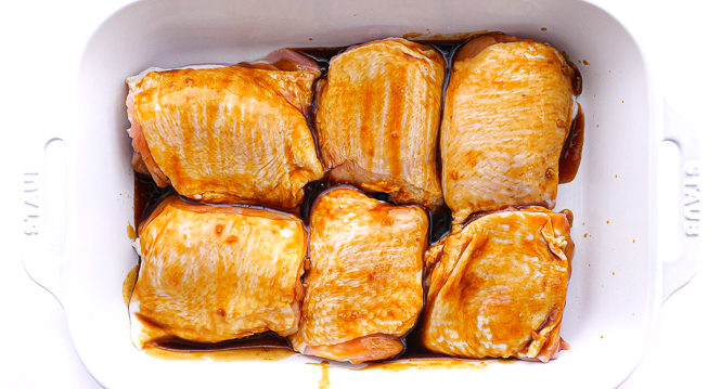 unbaked chicken thighs brushed with teriyaki sauce.